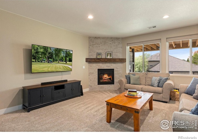 1603 Plank Ln, Fort Collins, CO 80524 - living room with visible vents, light carpet, a healthy amount of sunlight, and a fireplace