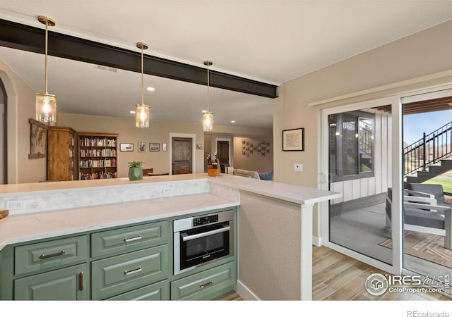 1603 Plank Ln, Fort Collins, CO 80524 - kitchen featuring light countertops, light wood finished floors, stainless steel oven, and green cabinets