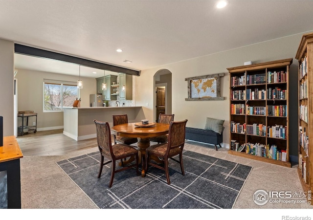 1603 Plank Ln, Fort Collins, CO 80524 - carpeted dining room with arched walkways, baseboards, and recessed lighting