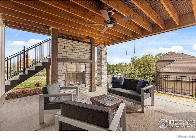 1603 Plank Ln, Fort Collins, CO 80524 - view of patio / terrace with ceiling fan, fence, stairs, and an outdoor living space with a fireplace