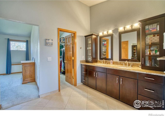 8574 W 94th Ave, Westminster, CO 80021 - bathroom with baseboards, a sink, a walk in closet, and double vanity