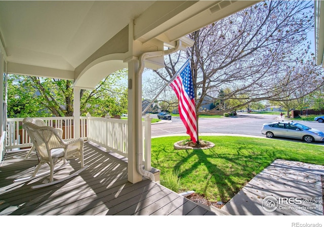 8574 W 94th Ave, Westminster, CO 80021 - deck with covered porch and a yard