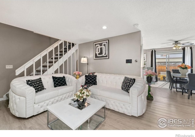 living area featuring stairs, recessed lighting, ceiling fan, and wood finished floors