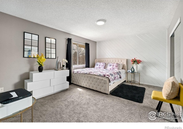 carpeted bedroom with a textured ceiling
