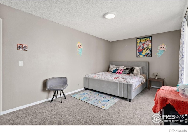 bedroom with carpet floors, baseboards, and a textured ceiling
