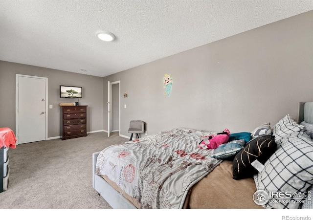 carpeted bedroom with baseboards and a textured ceiling