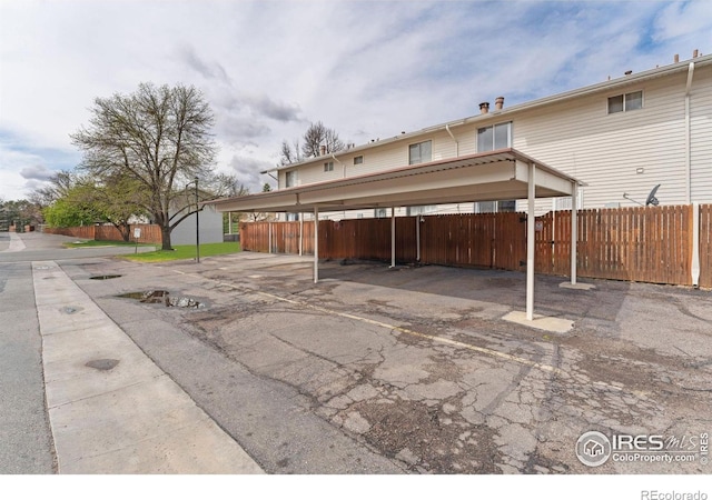 covered parking lot with fence