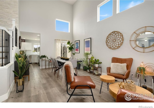 4400 Red Fox Ct, Loveland, CO 80537 - interior space with light wood-style floors, baseboards, a towering ceiling, and stairway