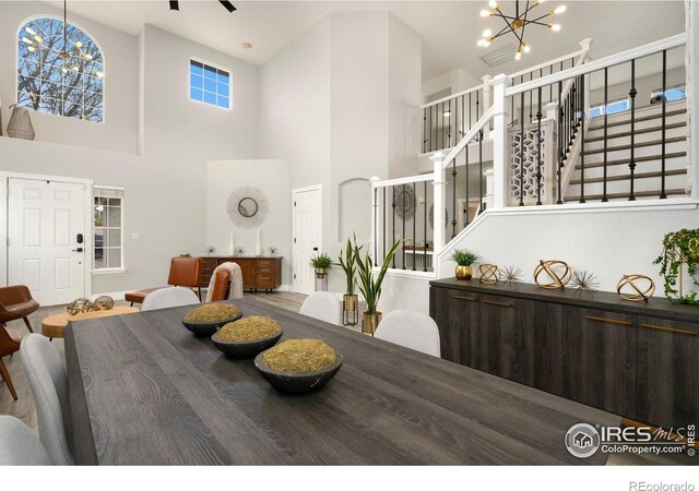 4400 Red Fox Ct, Loveland, CO 80537 - dining space with stairway, a high ceiling, and a chandelier
