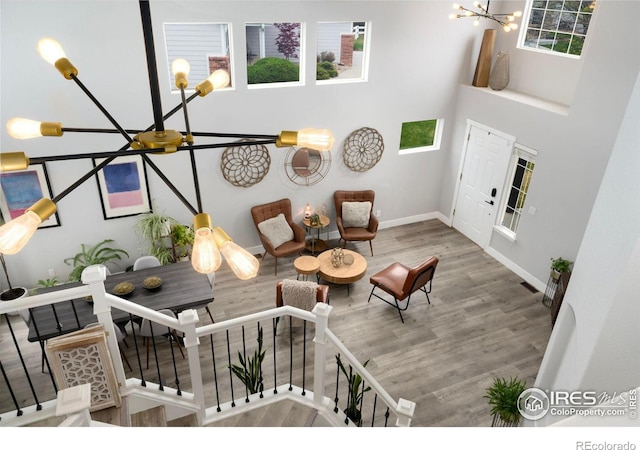 4400 Red Fox Ct, Loveland, CO 80537 - living area featuring baseboards, wood finished floors, and a notable chandelier