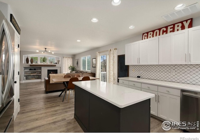 4400 Red Fox Ct, Loveland, CO 80537 - kitchen with a center island, tasteful backsplash, light countertops, open floor plan, and stainless steel appliances