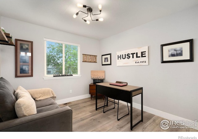 4400 Red Fox Ct, Loveland, CO 80537 - office space with an inviting chandelier, baseboards, and light wood-type flooring