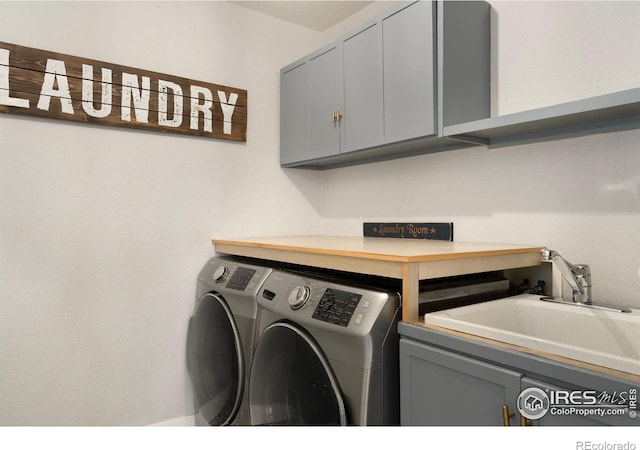 4400 Red Fox Ct, Loveland, CO 80537 - washroom with a sink, cabinet space, and washer and dryer