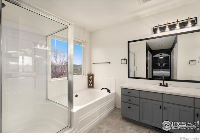 4400 Red Fox Ct, Loveland, CO 80537 - full bath with a garden tub, vanity, connected bathroom, an enclosed shower, and tile patterned floors