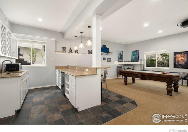 4400 Red Fox Ct, Loveland, CO 80537 - kitchen with a sink, a kitchen breakfast bar, open shelves, and white cabinets