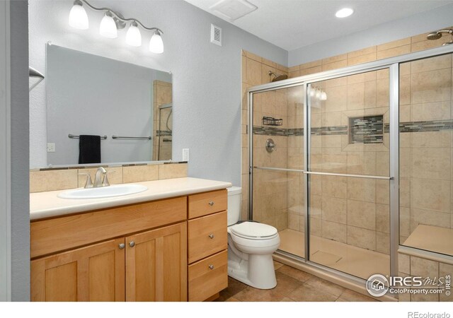 4400 Red Fox Ct, Loveland, CO 80537 - full bathroom featuring visible vents, tile patterned floors, a stall shower, and toilet