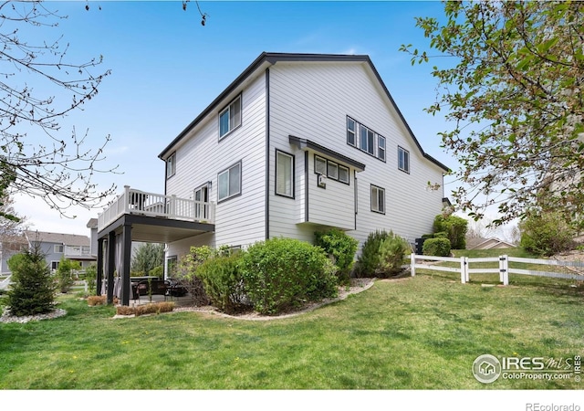 4400 Red Fox Ct, Loveland, CO 80537 - view of side of home featuring a lawn and fence