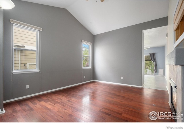 spare room with wood-type flooring, a ceiling fan, and lofted ceiling