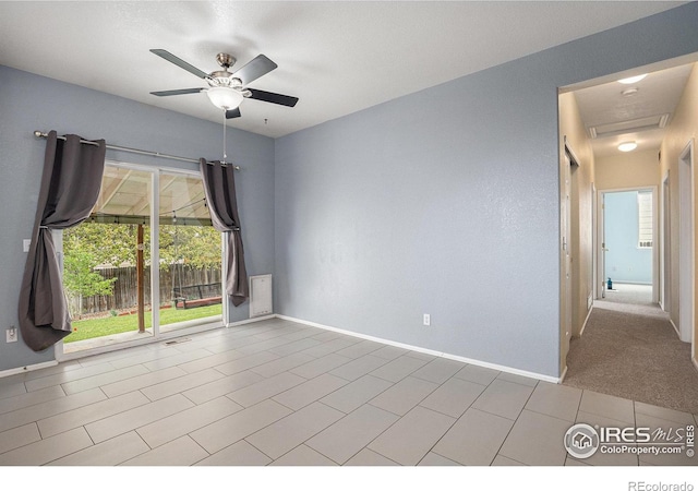 unfurnished room with baseboards, ceiling fan, tile patterned flooring, and visible vents