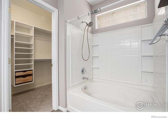full bathroom featuring baseboards,  shower combination, and a walk in closet