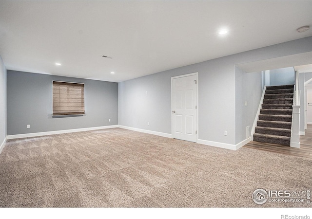 finished below grade area with recessed lighting, stairs, carpet floors, and baseboards