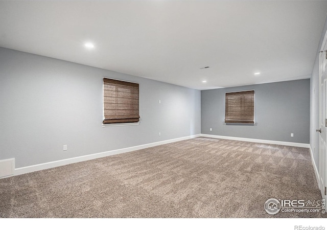 below grade area with carpet flooring, recessed lighting, and baseboards