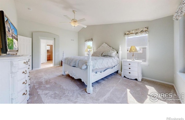 bedroom with light carpet, lofted ceiling, baseboards, and a ceiling fan