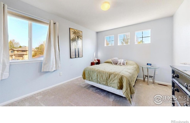 carpeted bedroom with baseboards