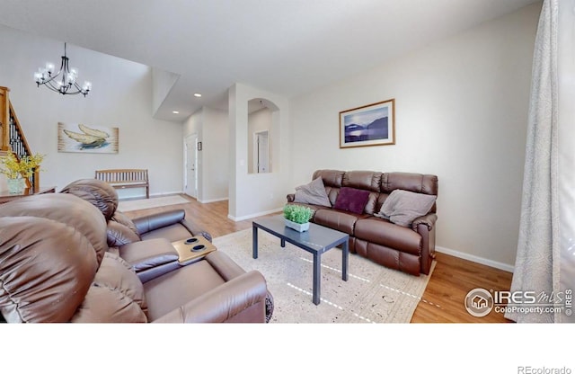 living area with a chandelier, wood finished floors, recessed lighting, and baseboards
