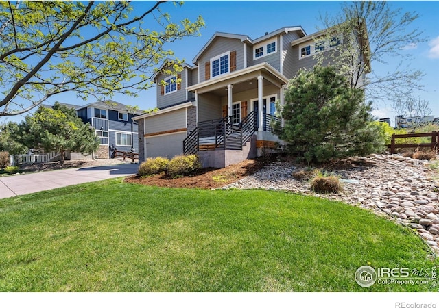 view of front of house with driveway, fence, a garage, a front yard, and a porch