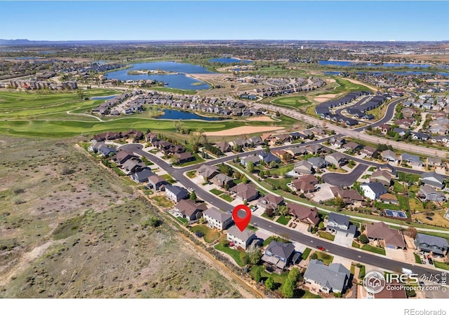 bird's eye view with a water view, golf course view, and a residential view