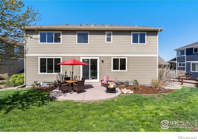 rear view of house with an outdoor fire pit, fence, a patio, and a lawn