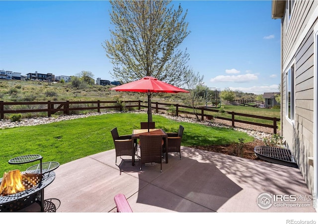 view of patio with an outdoor fire pit, outdoor dining area, a wooden deck, and a fenced backyard