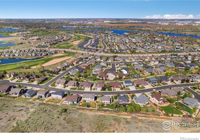 aerial view featuring view of golf course, a water view, and a residential view