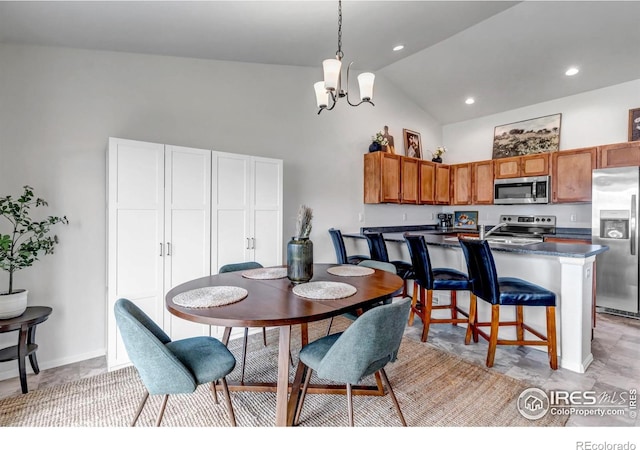 dining area featuring baseboards, a chandelier, and high vaulted ceiling