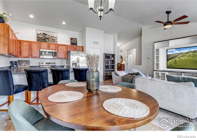 dining area featuring high vaulted ceiling, visible vents, built in features, and ceiling fan with notable chandelier