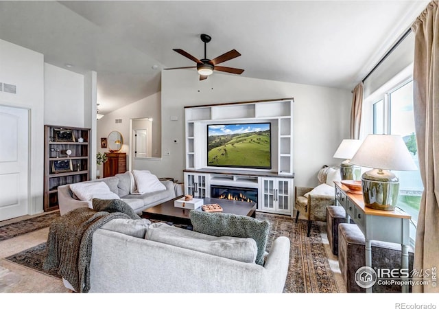 living area with a ceiling fan, vaulted ceiling, and visible vents