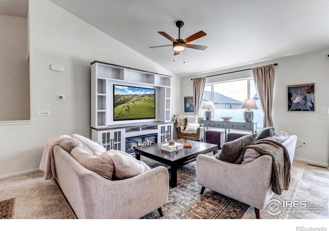 living area featuring visible vents, baseboards, ceiling fan, and vaulted ceiling