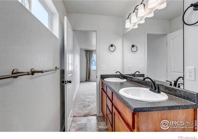 full bath with double vanity and a sink