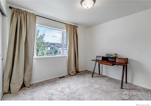 office space featuring baseboards, carpet, and visible vents