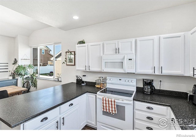 kitchen featuring white appliances, a peninsula, and white cabinets