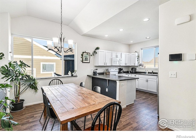 kitchen with white appliances, white cabinetry, dark countertops, and dark wood-style floors