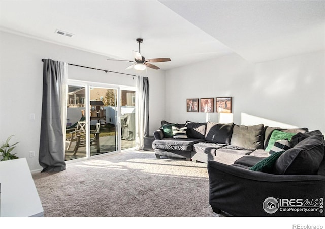 carpeted living room with visible vents and a ceiling fan
