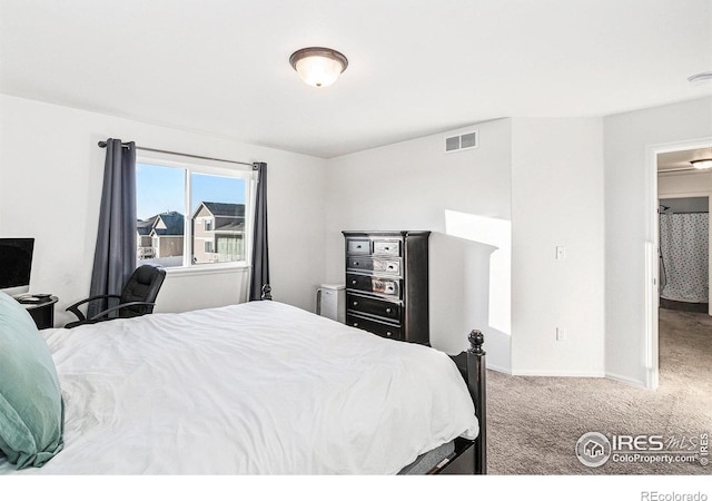 carpeted bedroom featuring visible vents and baseboards