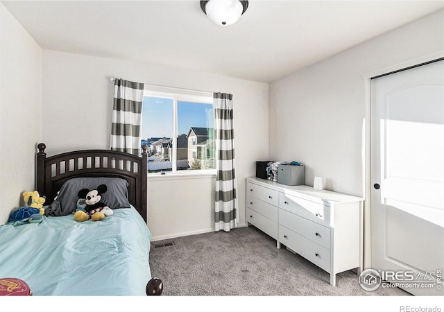 bedroom with baseboards, light carpet, and visible vents