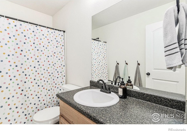 bathroom with vanity, toilet, and a shower with curtain