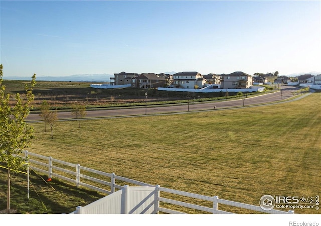 view of yard with fence and a residential view