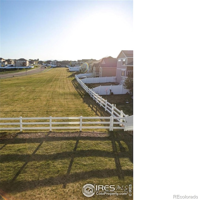 view of yard featuring fence and a residential view