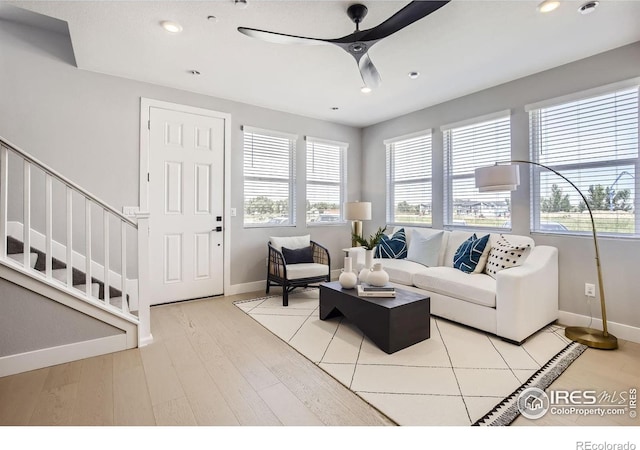 living area featuring recessed lighting, ceiling fan, and baseboards