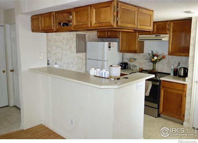 6036 Gunbarrel Ave Unit B, Boulder, CO 80301 - kitchen featuring freestanding refrigerator, electric range, light countertops, under cabinet range hood, and backsplash